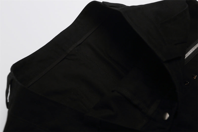 Close-up of black shorts waistband and side seam with zipper detail