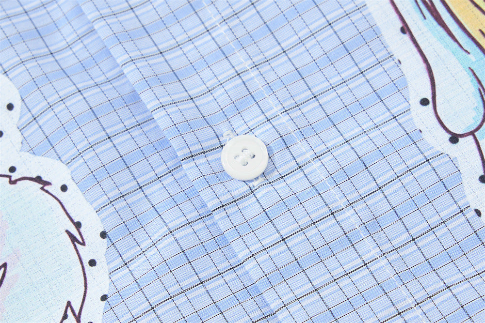 Blue plaid fabric close-up with a white button and printed anime edge
