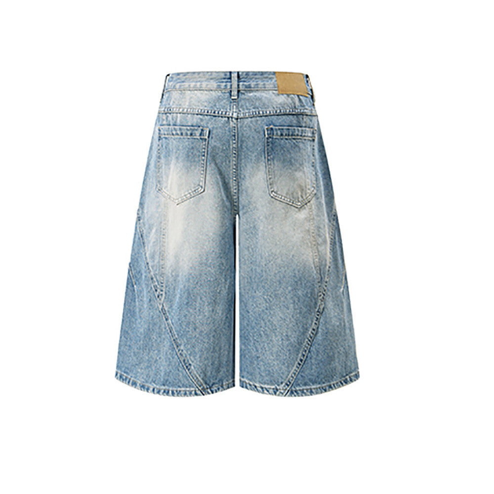 Back view of light blue wide-leg denim shorts with faded patches and rear pockets