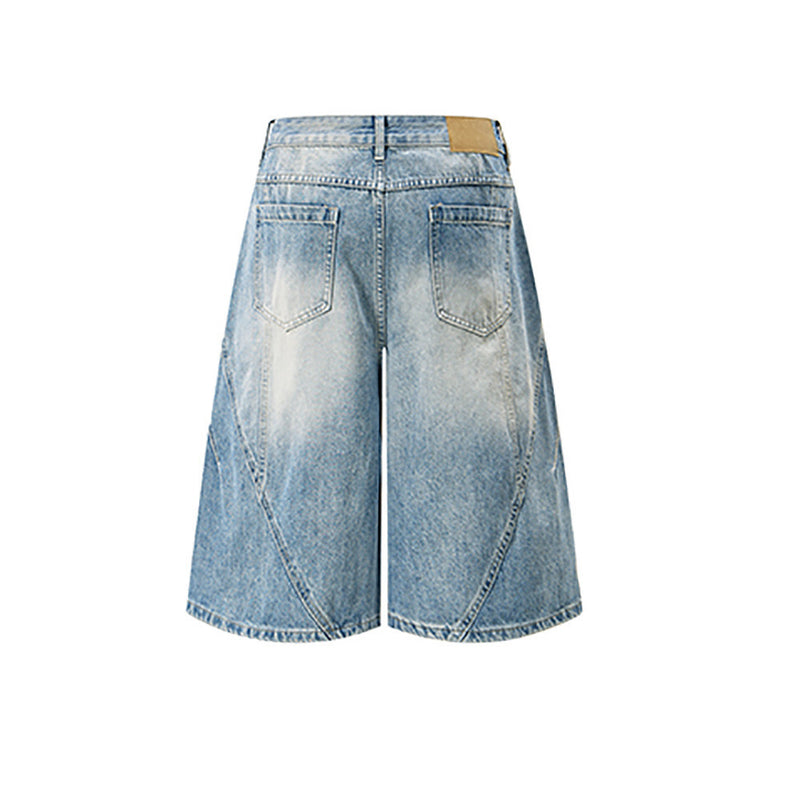 Back view of light blue wide-leg denim shorts with faded patches and rear pockets