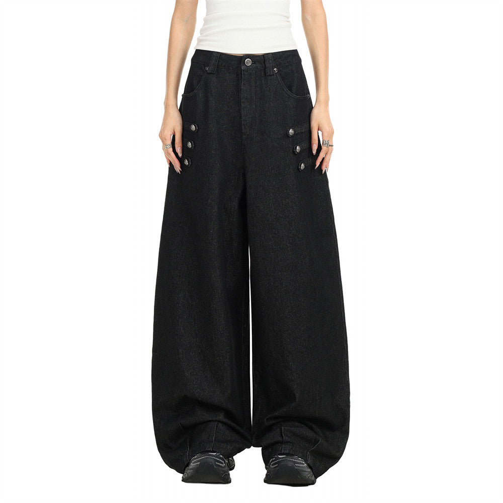 Black wide-leg denim jeans with pleated waist and button details, front view on model