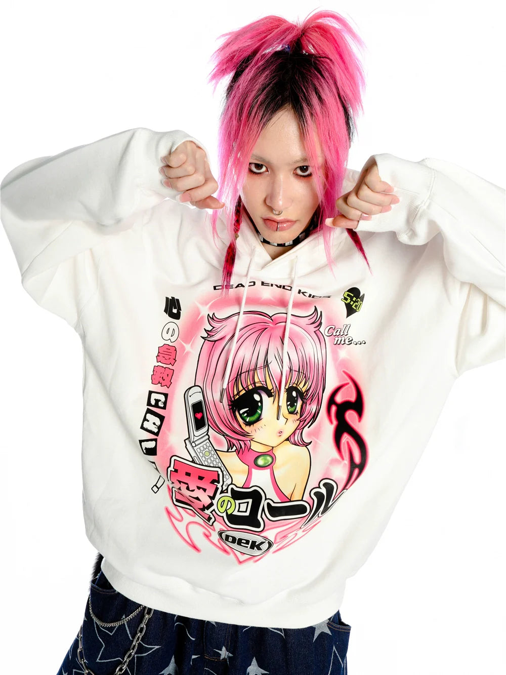 With pink hair, a person exudes playfulness in the Seakoff Y2K Aesthetic Anime Hoodie. The retro manga girl graphic and kawaii phone design truly embody the kawaii style as they strike a fun pose, tugging at the hood's strings with both hands.