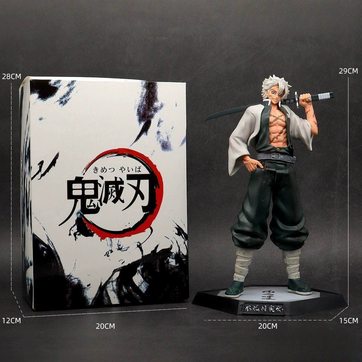 The 29 cm Shinjuro Rengoku PVC Figure from Demon Slayer, wearing loose pants and an open vest while wielding a sword, stands next to its box adorned with Japanese text and ink splatters. The box measures 28 cm.