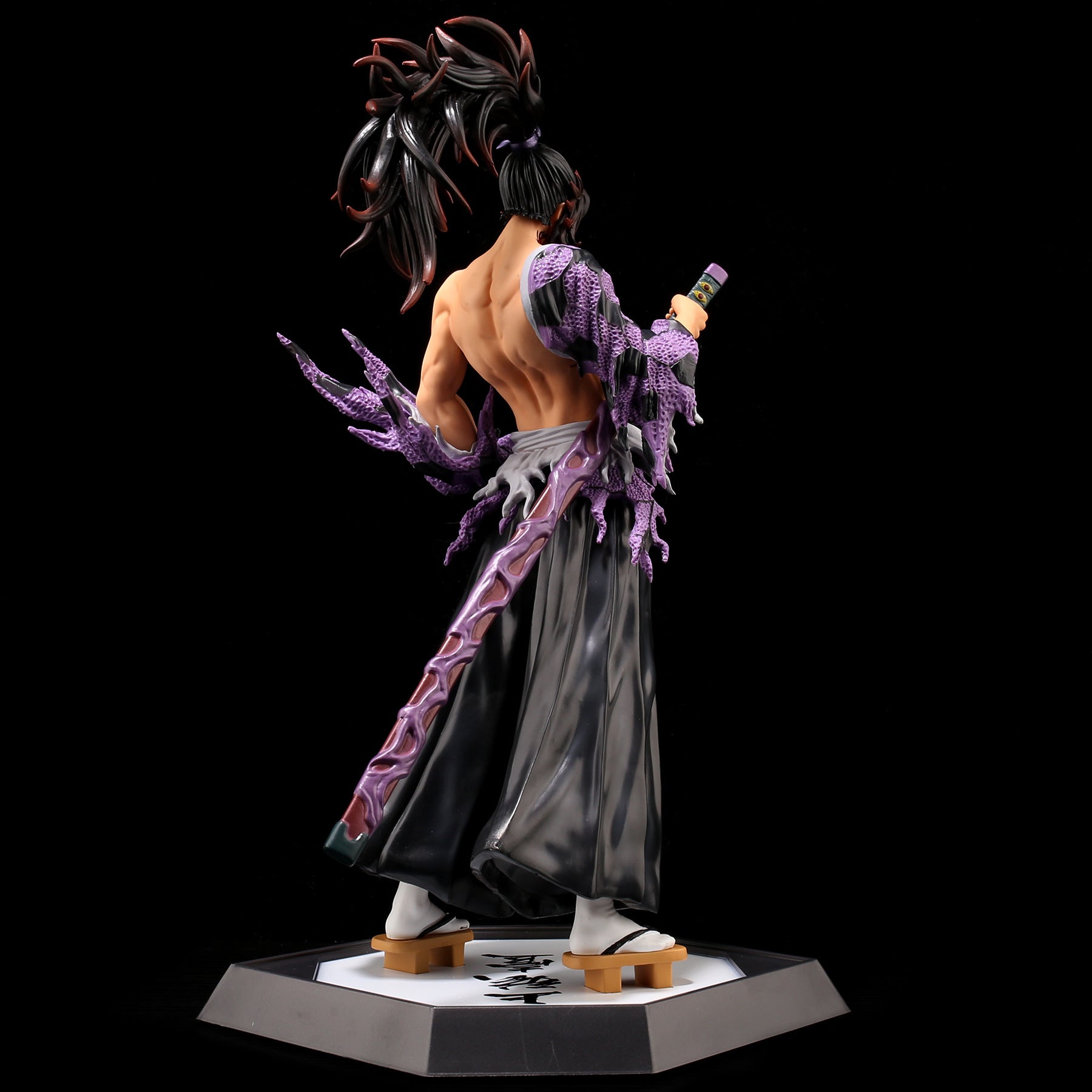 The Kokushibo Demon Slayer Figure, a 31CM PVC action figure by Demon Slayer, captivates Kimetsu no Yaiba fans on its hexagonal base with long spiked hair, an elaborate costume, and a muscular bare back featuring exaggerated purple claw-like features while wielding a formidable sword.