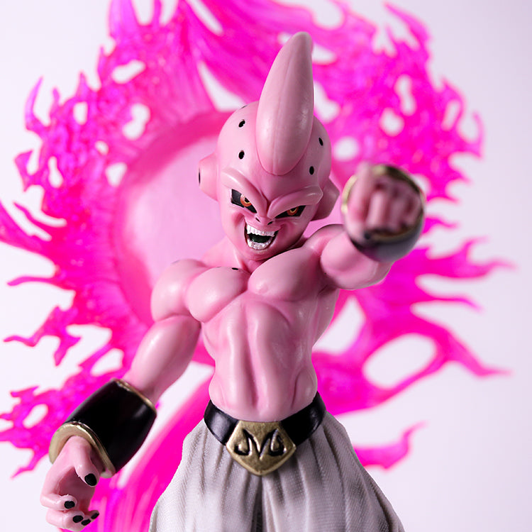 The Seakoff Majin Buu Collectible Figure from Dragon Ball Z features a pink humanoid with a tall, pointed head, white pants, and black wristbands. This 37cm figure stands in a dynamic pose and is surrounded by a dramatic, glowing pink aura.