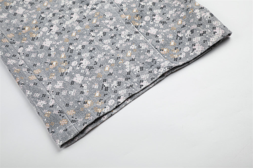 Close-up of wide-leg pant hem in gray mosaic floral print fabric