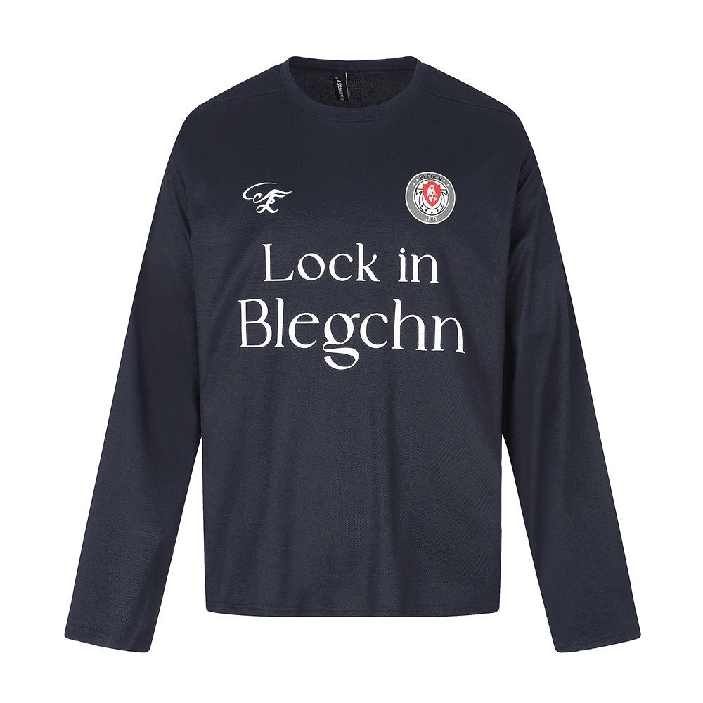 Black long sleeve crew neck tee, flat lay front view with chest graphic and logo patch