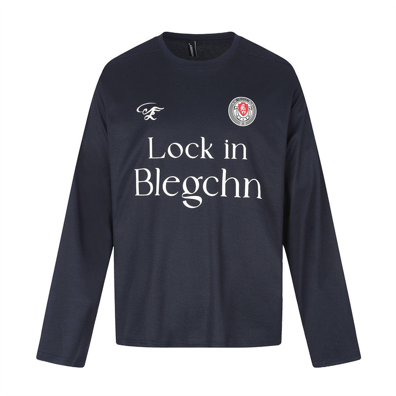 Black long sleeve crew neck tee, flat lay front view with chest graphic and logo patch