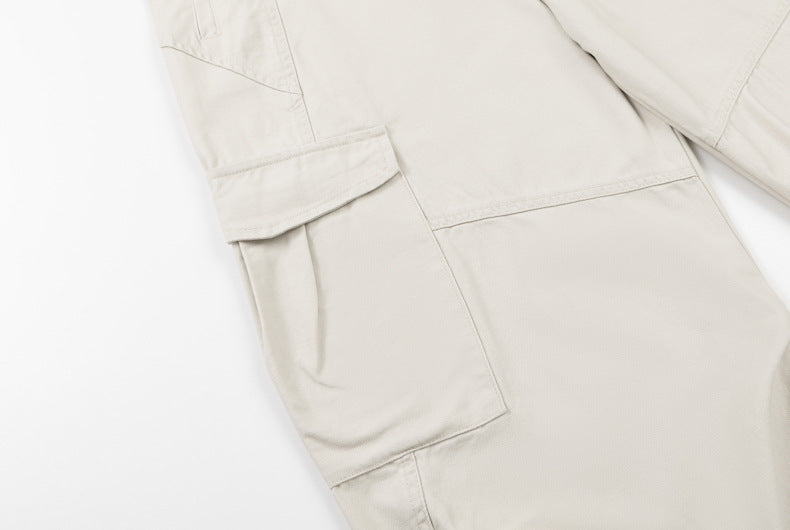 Cream cargo pants close-up of flap pocket and side panel