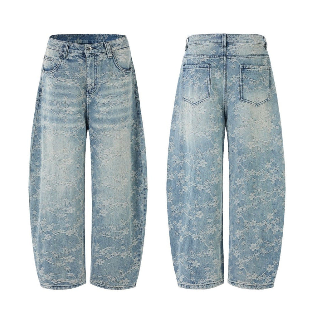 Men's loose fit wide-leg jeans with all-over white floral lace embroidery on washed light blue denim, front and back view