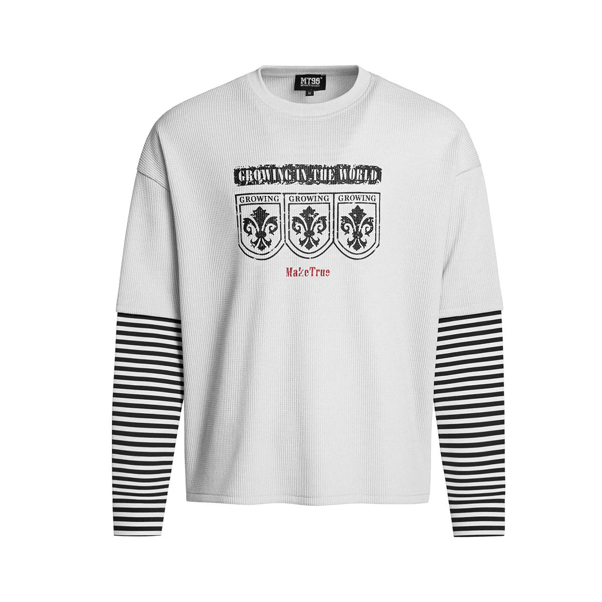 Oversized faux-layered long sleeve graphic shirt with black and white striped sleeves and heraldic crest print, shown in whit