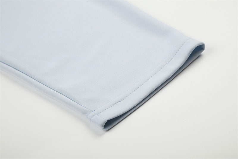 Close-up of light blue sleeve cuff with stitched hem