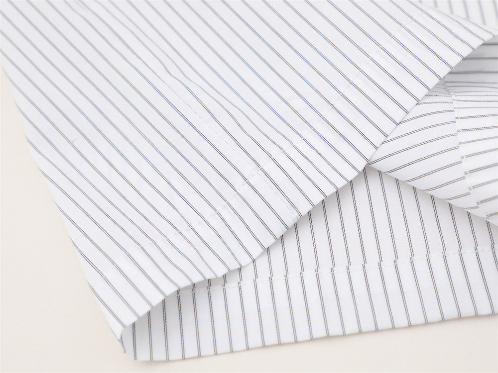 White striped shirt hem and sleeve cuff detail close-up