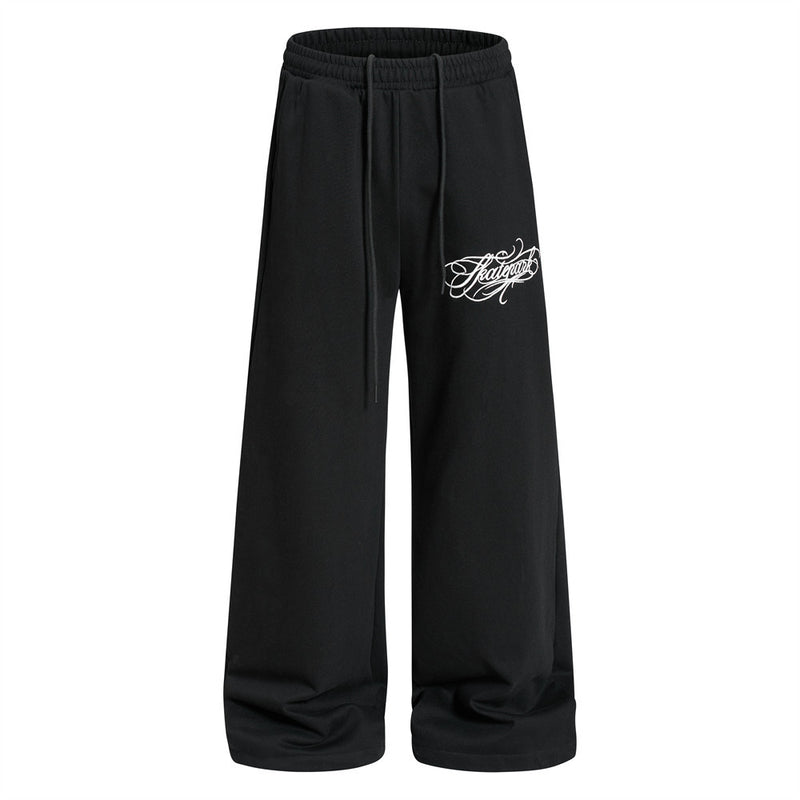 Skatepark script logo wide-leg sweatpants in black with cargo pockets and tattoo-style calligraphy print