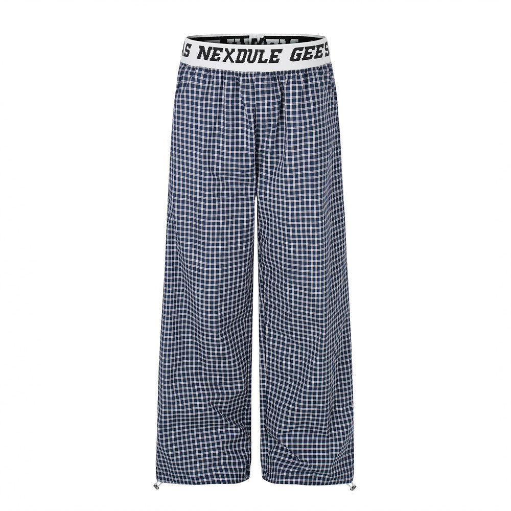 Navy plaid wide-leg pants with white logo elastic waistband, front view