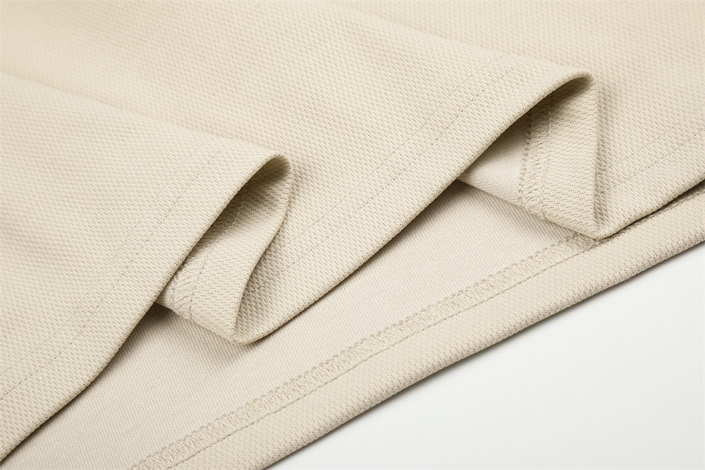 Beige sleeve and hem seam detail on textured long sleeve tee