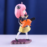 The Anya Forger Chainsaw Cosplay Figure is an 18CM PVC action figure from Spy × Family, featuring the pink-haired character holding a small orange creature with an open mouth. She&