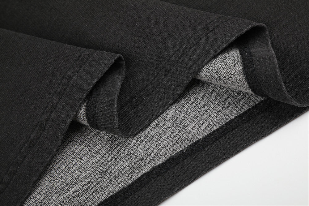 Close-up of black sleeve hem and gray inner fabric lining