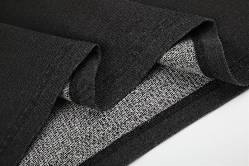 Close-up of black sleeve hem and gray inner fabric lining