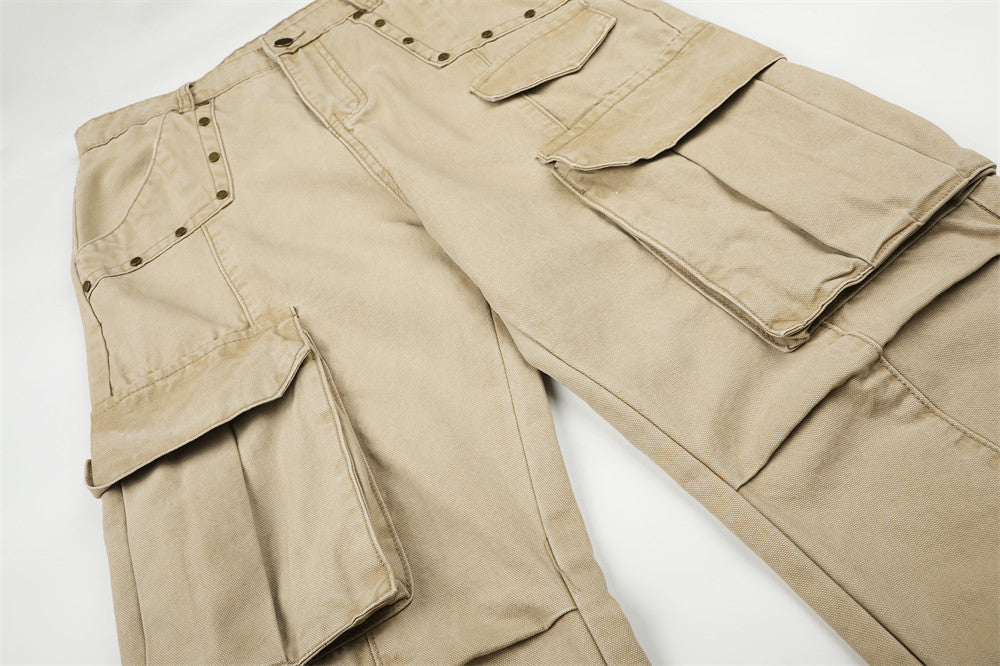 Close-up of beige cargo pants upper leg with layered flap cargo pockets