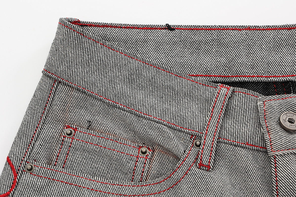 Jean wide leg bicolore à empiècements contrastants et broderie manuscrite – Coupe droite en denim brut