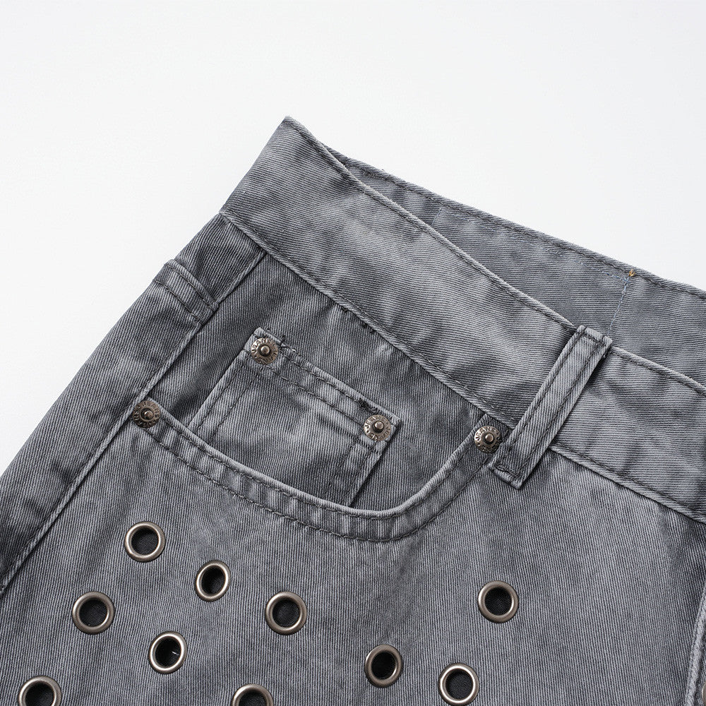 Close-up of back waistband and pocket on washed grey jeans with tan label