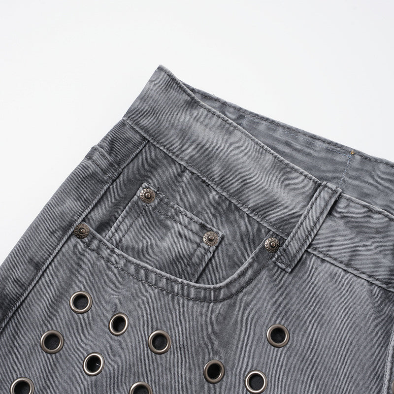 Close-up of back waistband and pocket on washed grey jeans with tan label