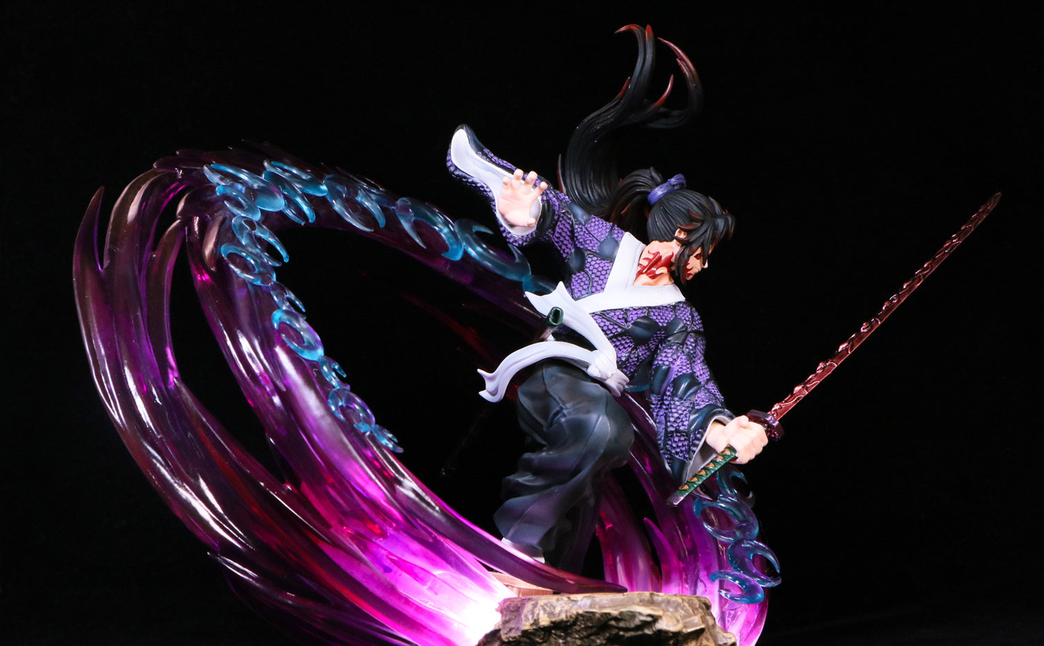 The Kokushibo Demon Slayer Figure is a 30cm PVC statue showcasing the anime warrior with long black hair and a sword, surrounded by swirling purple and blue glowing effects against a black backdrop. This premium collectible is ideal for any fan&