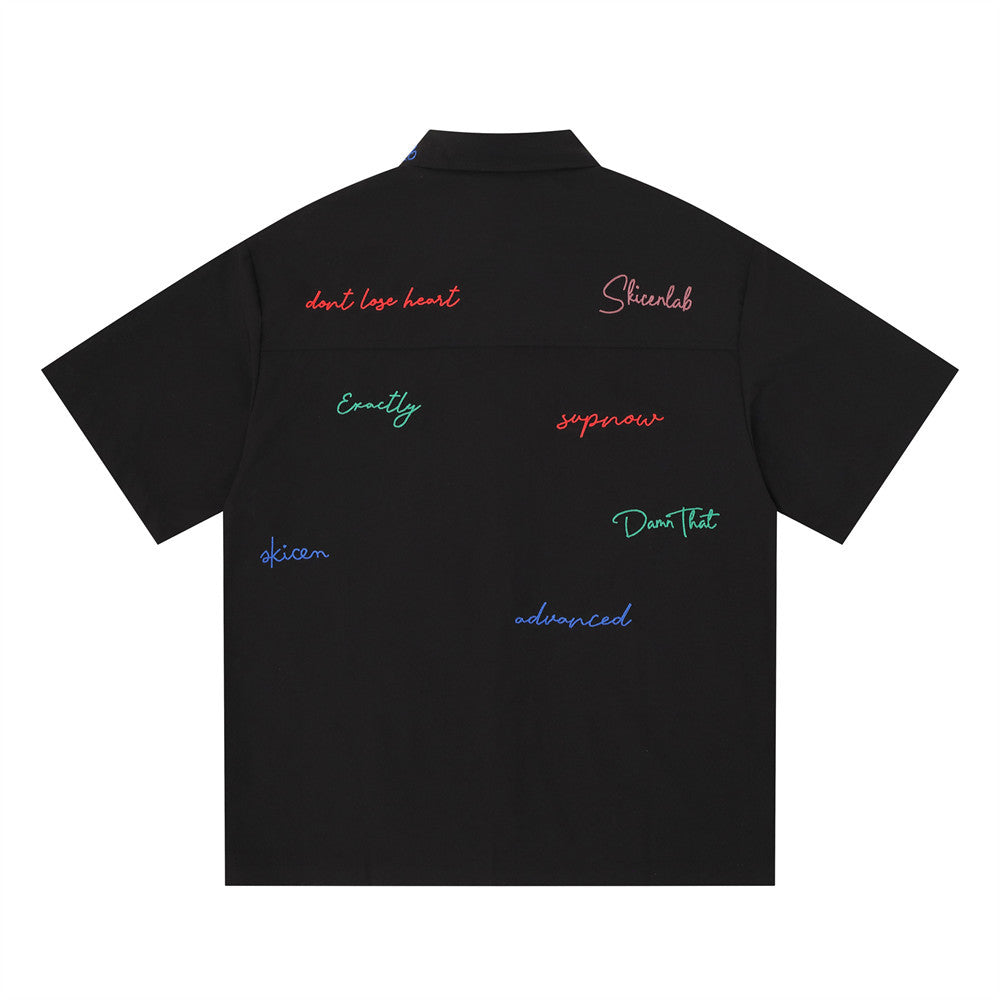 Black short sleeve button-down shirt with multicolor graffiti script embroidery, back view