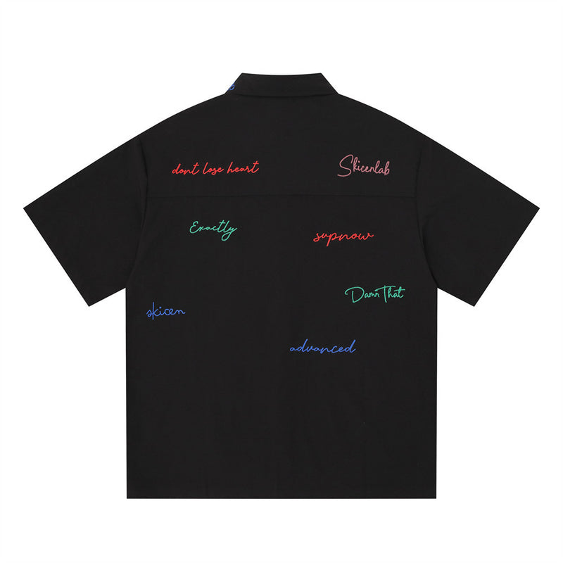 Black short sleeve button-down shirt with multicolor graffiti script embroidery, back view
