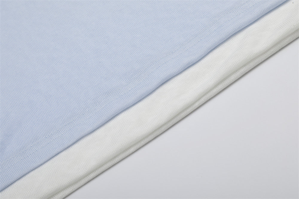 Close-up of light blue and white layered hem on long sleeve tee