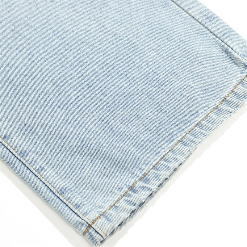 Close-up of light wash denim hem with stitched edge