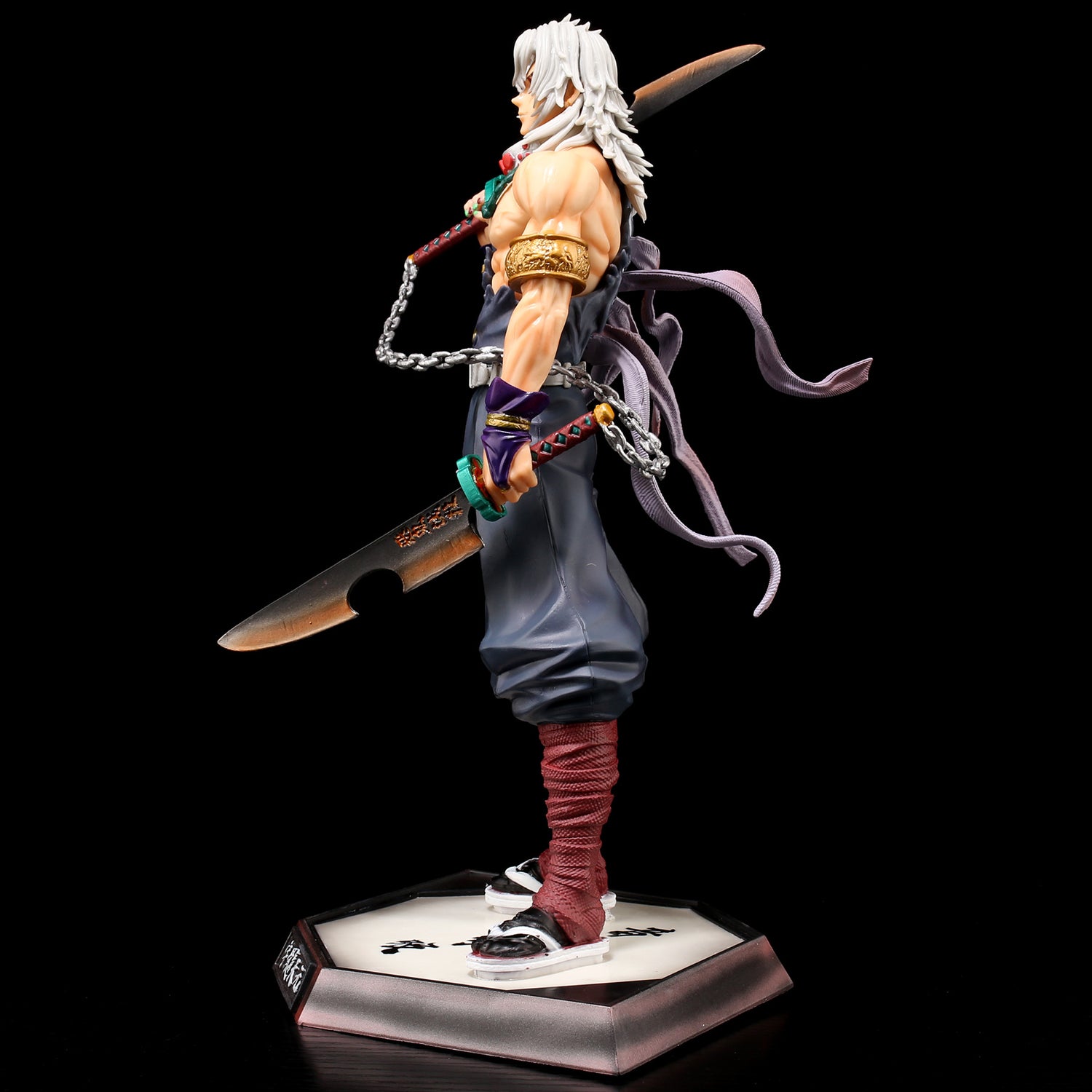 Side view of Ubuyashiki Tengen from Demon Slayer, showcasing white hair and a sword. The figure features a sleeveless top, pants, boots with chains, and ribbons. It stands on a hexagonal base with text against a black background. Height: 30cm; High-quality collectible by Demon Slayer.