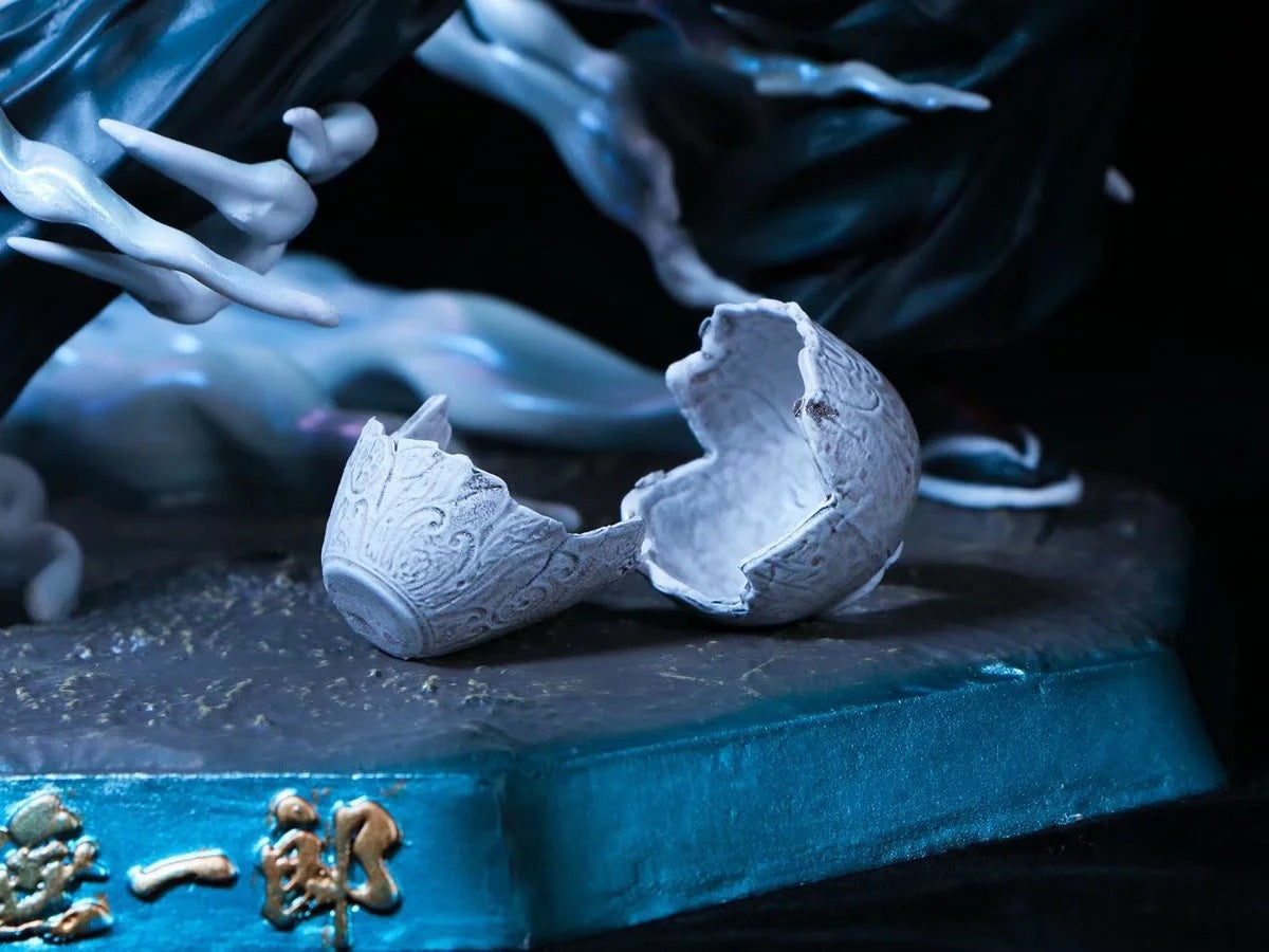 On a textured surface lies a broken, intricately carved white ceramic cup. The backdrop suggests flowing fabric-like figures akin to Mist Breathing techniques. Its teal base with golden accents hints it might belong to the Seakoff Muichiro Tokito Demon Slayer Figure collection, 18cm PVC collectible.