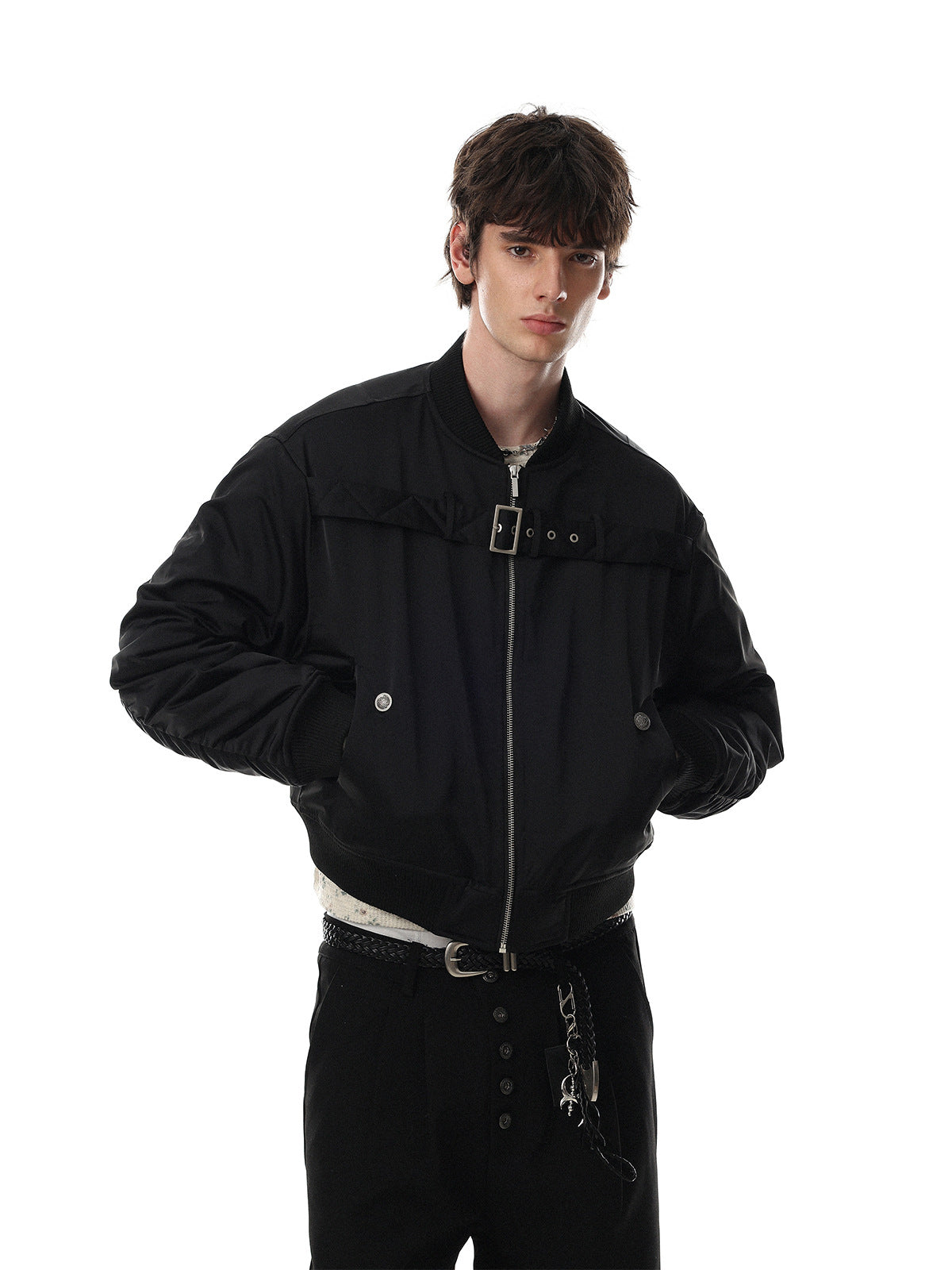 Men's oversized padded bomber jacket with chest buckle strap in black, front view