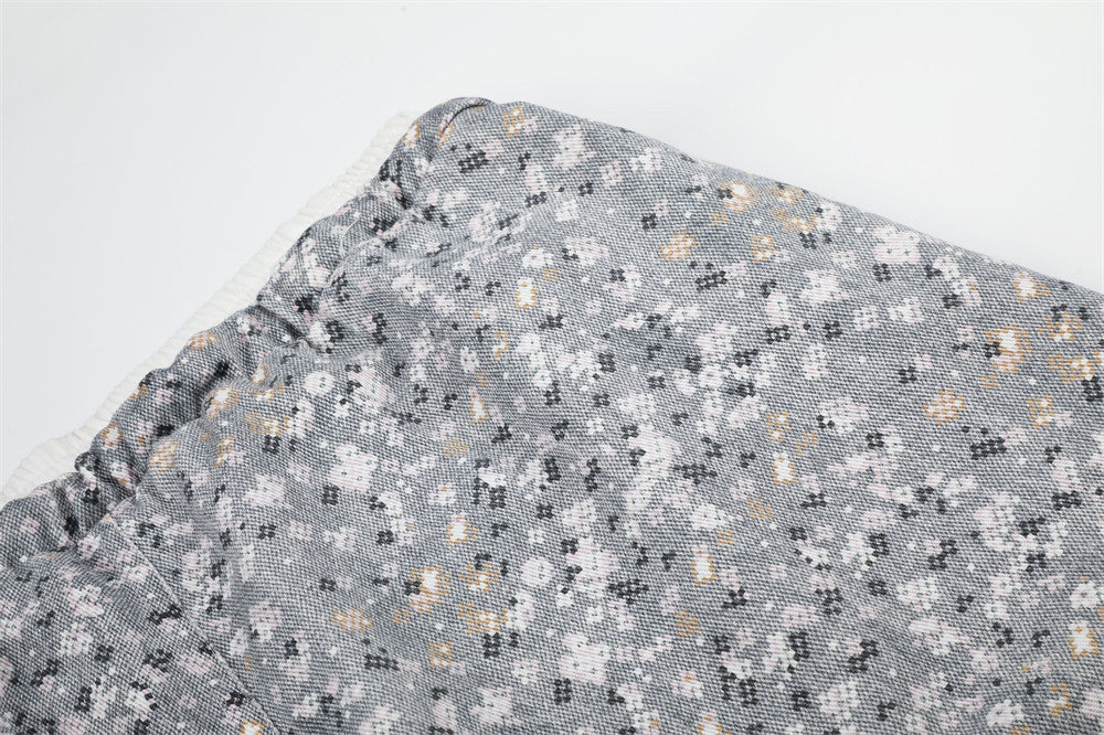 Close-up of gray floral print fabric and waistband seam