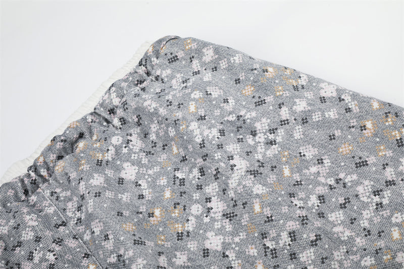 Close-up of gray floral print fabric and waistband seam