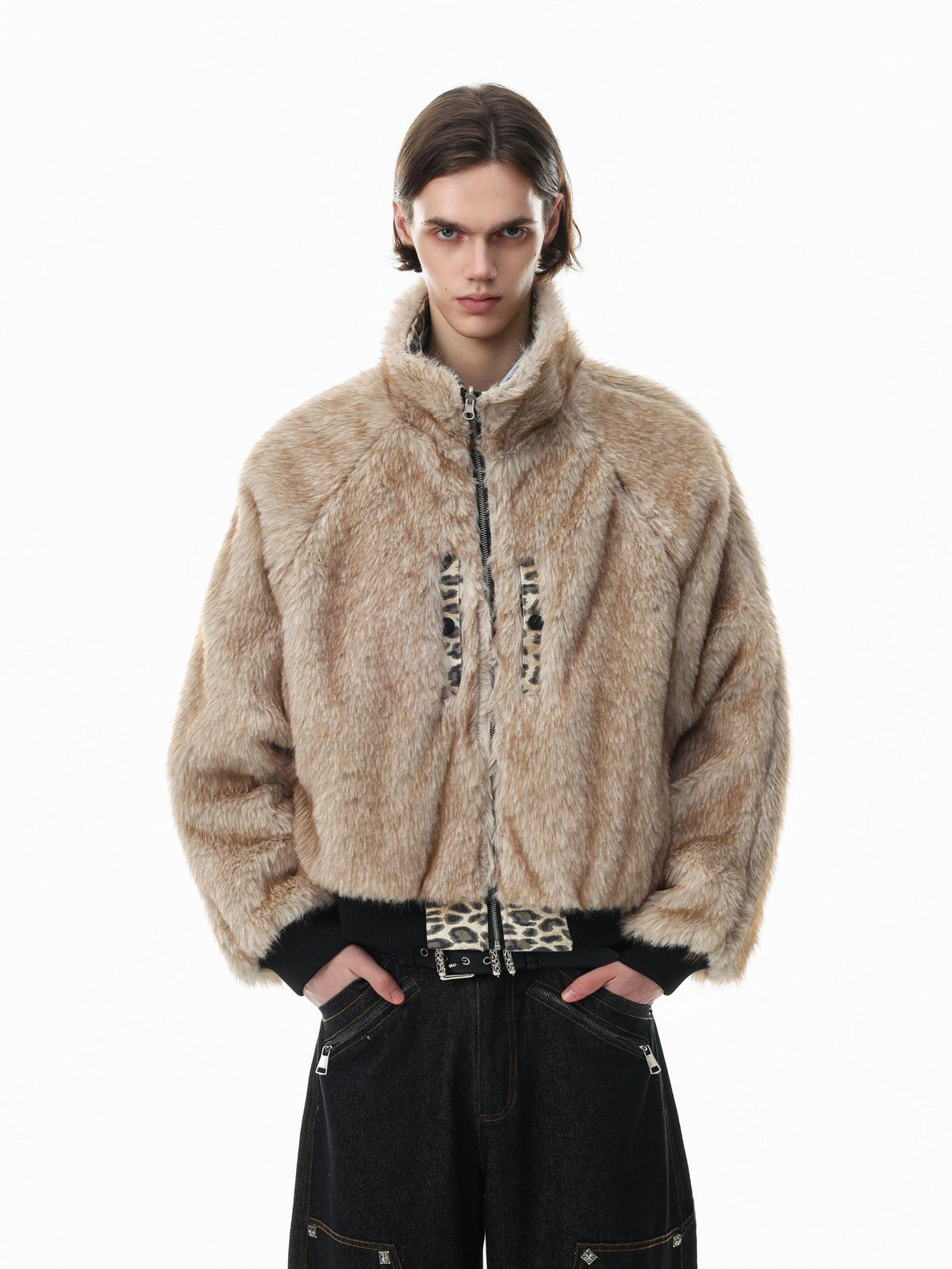 Reversible oversized faux fur and leopard print bomber jacket in beige, worn by male model with black wide-leg denim