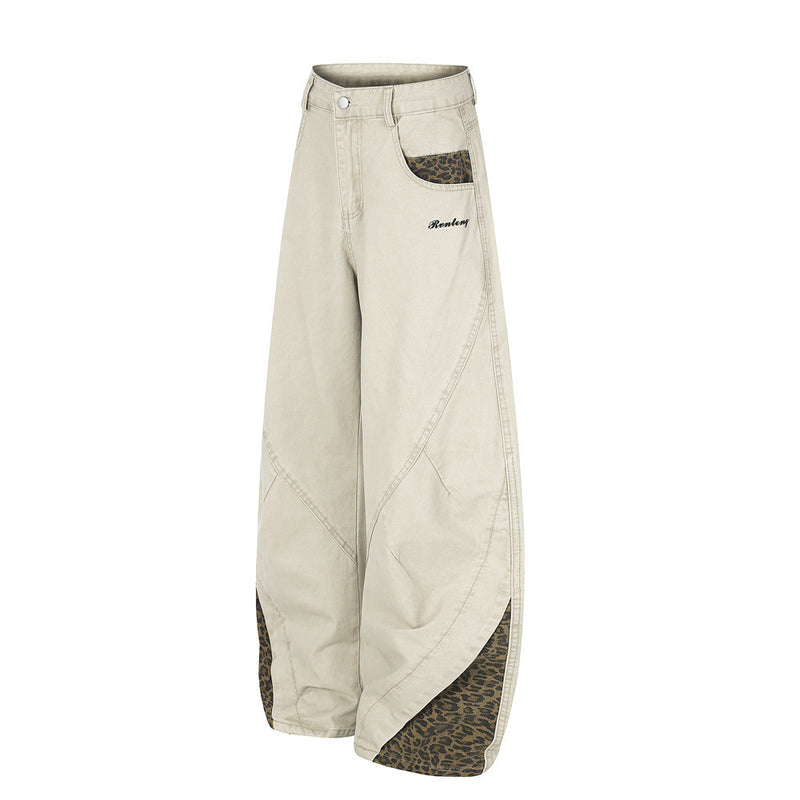 Pantalones de Pierna Ancha con Patchwork de Leopardo – Corte Baggy Deconstruido y Bajo Curvado
