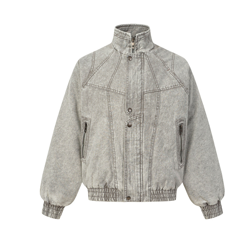 Oversized washed denim padded bomber jacket with deconstructed geometric panels and contrast topstitching in washed grey