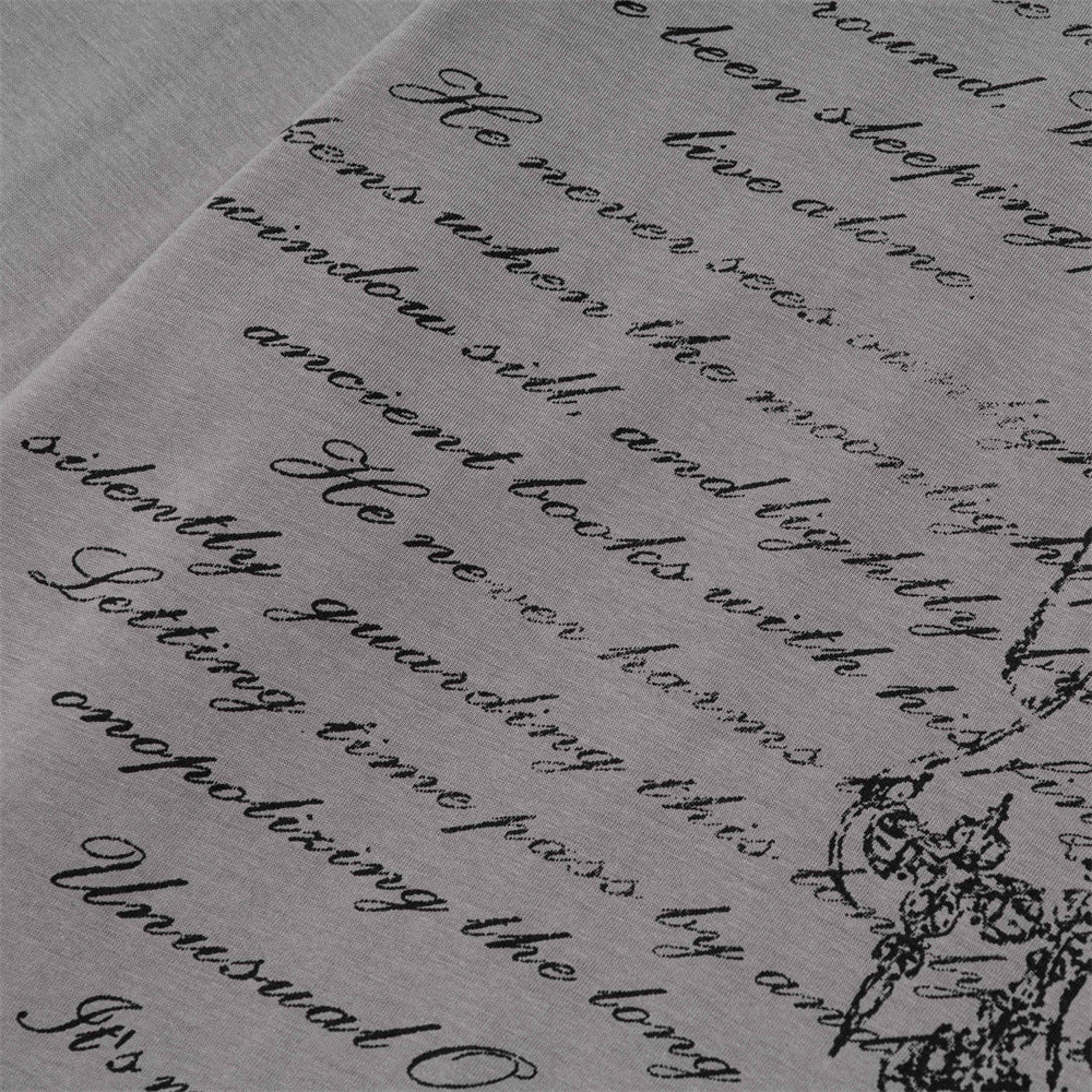 Close-up of gray T-shirt script text print on the front graphic