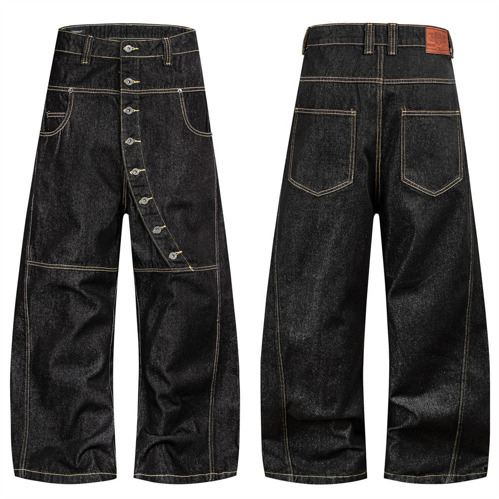 Men's raw black wide-leg denim jeans with diagonal button fly and yellow contrast topstitching, front and back view