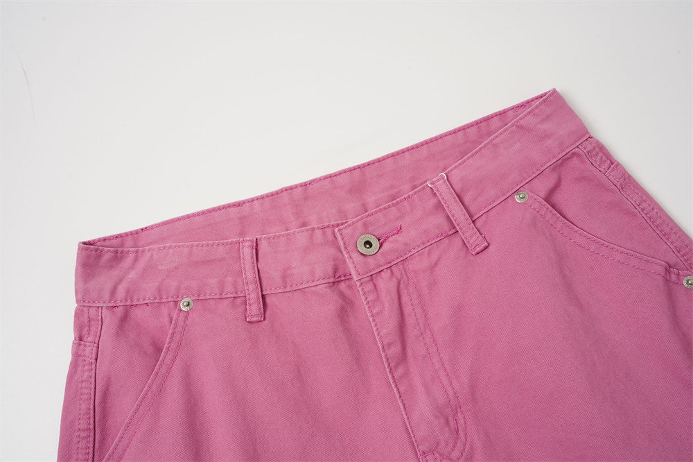 Close-up of rose pink shorts waistband and front button closure