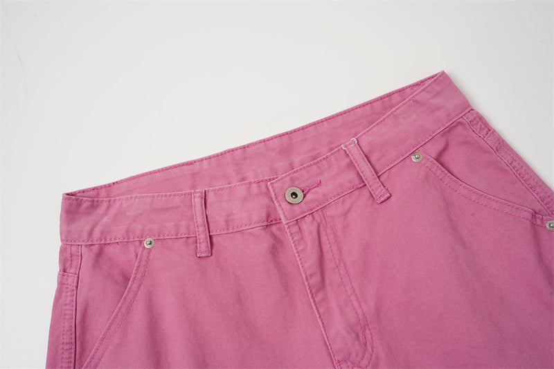 Close-up of rose pink shorts waistband and front button closure