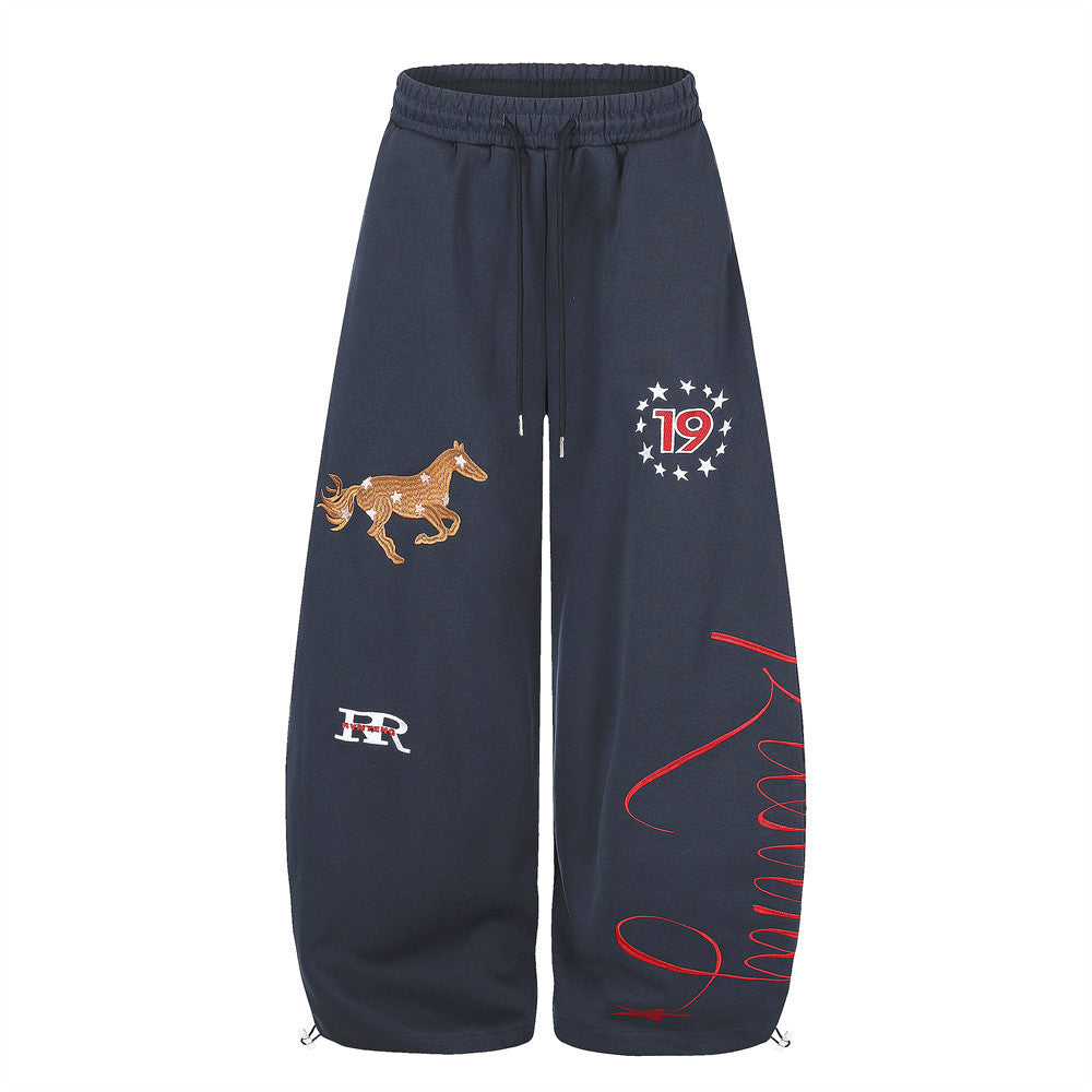 Men's wide-leg sweatpants with horse embroidery and star graphic in navy, front view
