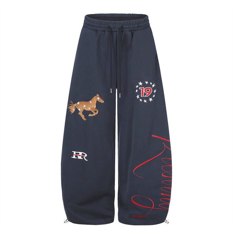 Men's wide-leg sweatpants with horse embroidery and star graphic in navy, front view