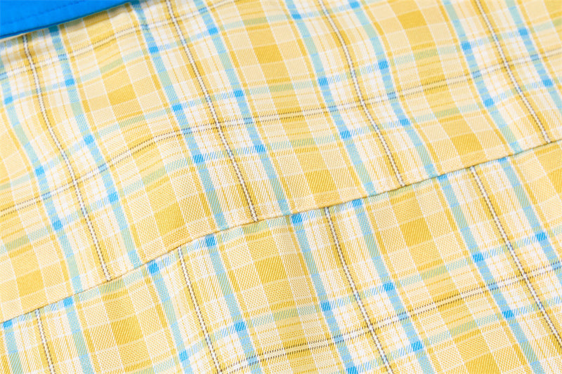 Close-up of back shoulder seam on yellow plaid shirt