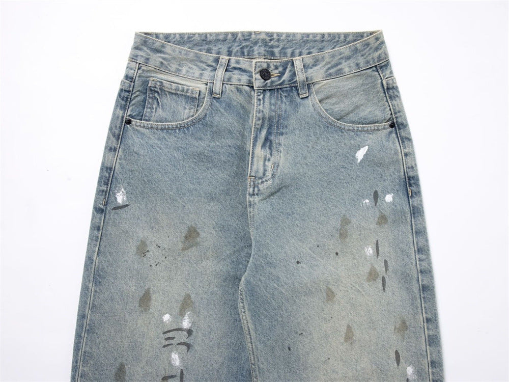 Waist detail of light wash jeans with button closure, belt loops, and front pockets