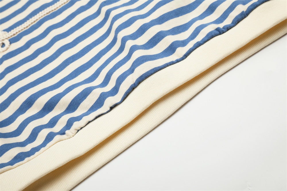Close-up of blue and cream striped shirt hem with contrast cream trim