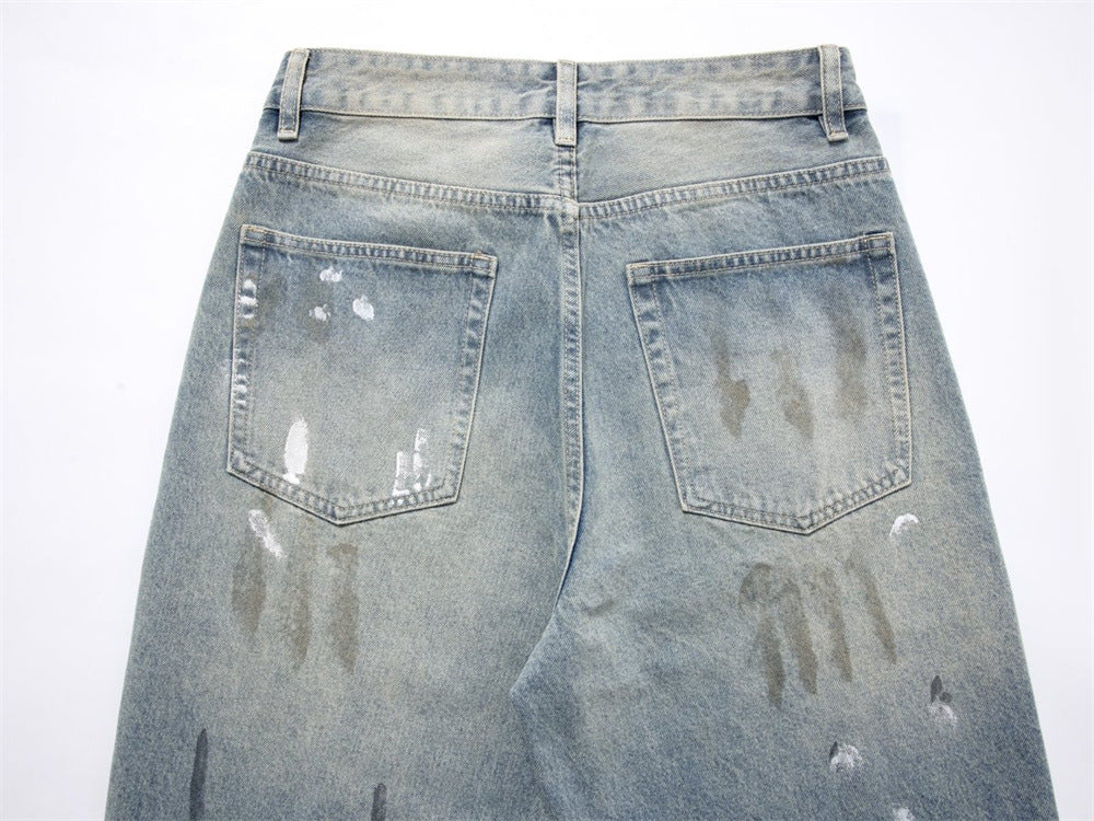 Back view of jeans upper section with two patch pockets and paint splatter